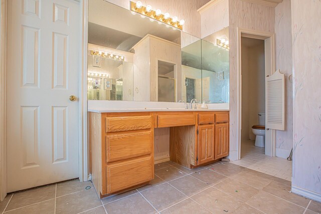 bathroom with an enclosed shower, tile patterned flooring, vanity, and toilet