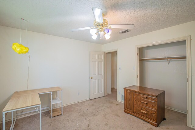 bedroom with visible vents, light carpet, a closet, a textured ceiling, and ceiling fan
