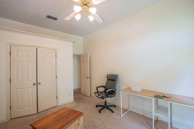 home office with carpet floors, a ceiling fan, visible vents, and baseboards