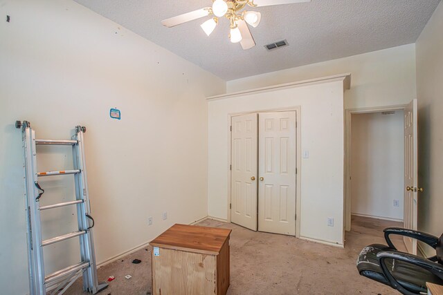 unfurnished bedroom with light carpet, a textured ceiling, visible vents, a closet, and ceiling fan
