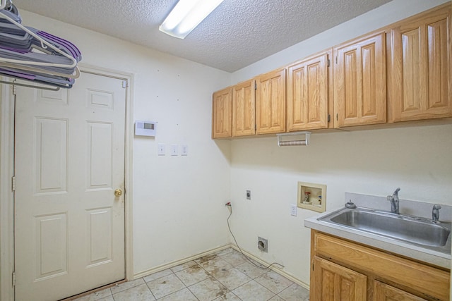 laundry area with a sink, hookup for an electric dryer, cabinet space, washer hookup, and a textured ceiling