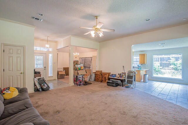 living room with visible vents, light carpet, ornamental molding, a textured ceiling, and ceiling fan with notable chandelier