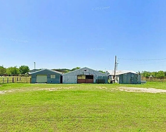 458 Jackson Ave, Strawn, TX 76475 - view of yard featuring fence, an outbuilding, and a pole building