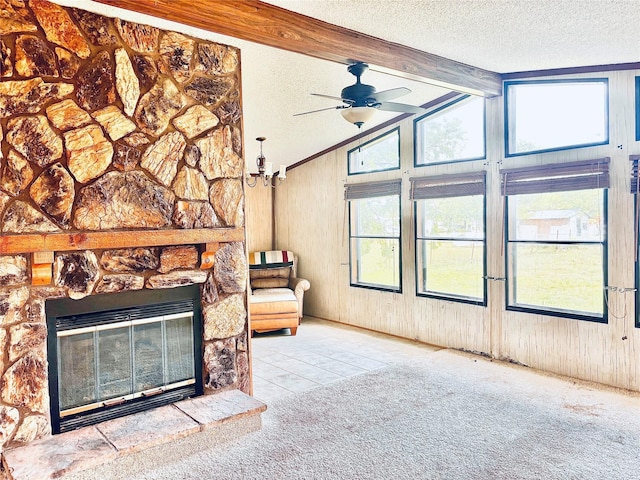 458 Jackson Ave, Strawn, TX 76475 - living room with wooden walls, a ceiling fan, a textured ceiling, and vaulted ceiling with beams