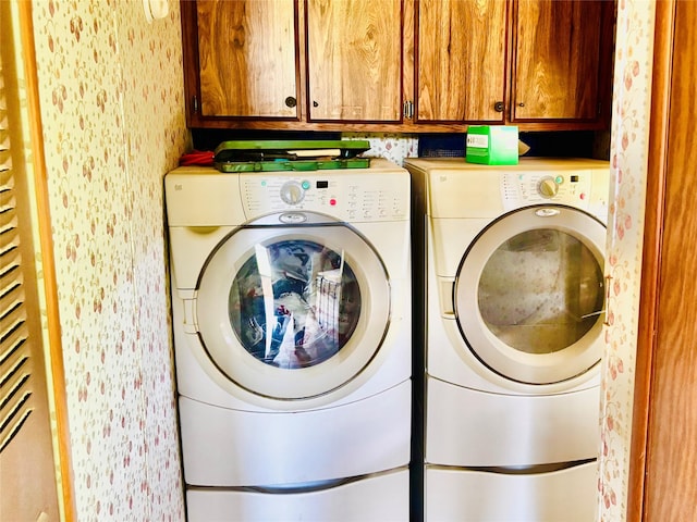 458 Jackson Ave, Strawn, TX 76475 - laundry area featuring washing machine and dryer, wallpapered walls, and cabinet space