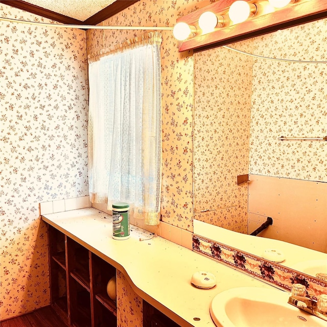 458 Jackson Ave, Strawn, TX 76475 - bathroom featuring wallpapered walls, wood finished floors, vanity, and ornamental molding