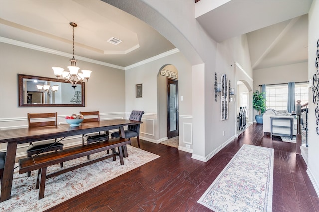 14225 Signal Hill Dr, Little Elm, TX 75068 - dining area with a chandelier, arched walkways, a tray ceiling, wood-type flooring, and ornamental molding
