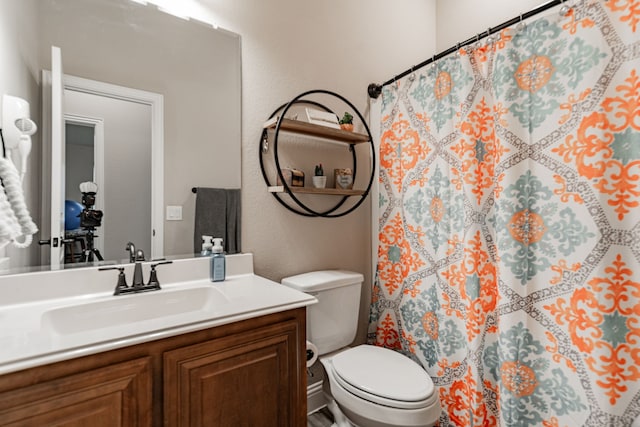 full bathroom featuring toilet, vanity, and a shower with curtain