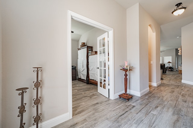 hallway with baseboards and wood finished floors