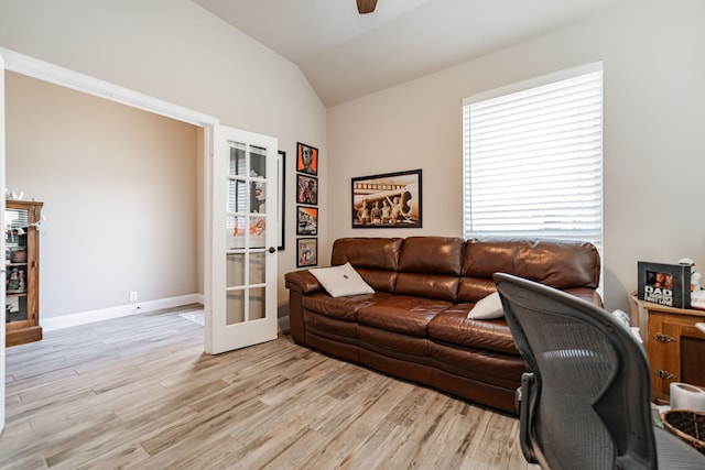 office with french doors, light wood-type flooring, vaulted ceiling, baseboards, and a ceiling fan