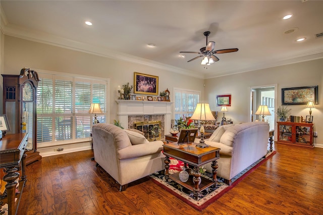 living room with recessed lighting, wood finished floors, ceiling fan, crown molding, and a high end fireplace