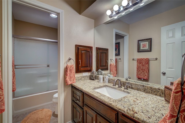 bathroom featuring tile patterned flooring, toilet, vanity, and enclosed tub / shower combo