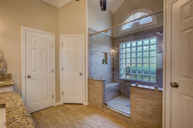 full bathroom with a shower stall, vanity, and ornamental molding