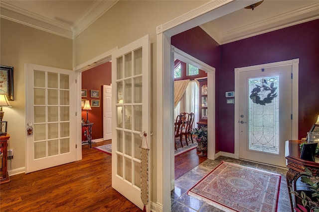 foyer entrance with baseboards, crown molding, french doors, and wood finished floors