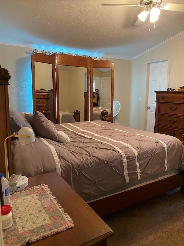 bedroom with ceiling fan, vaulted ceiling, and ornamental molding