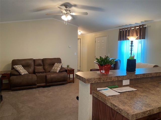 carpeted living room featuring ceiling fan, vaulted ceiling, and ornamental molding