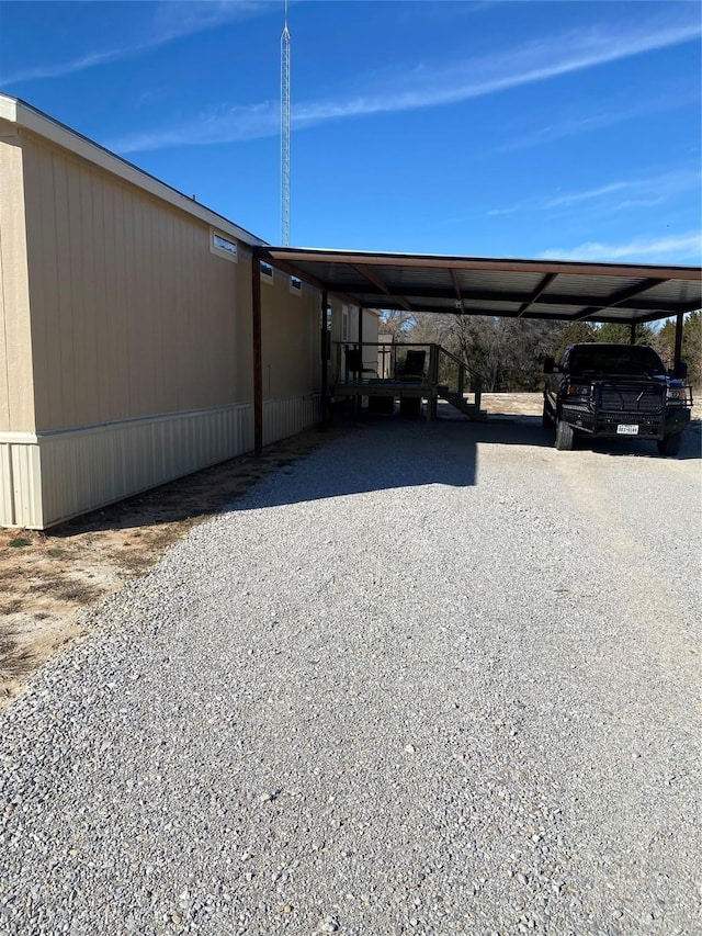 view of vehicle parking with driveway and an attached carport