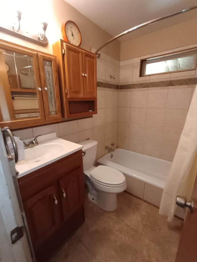 full bath featuring vanity, toilet, tile patterned flooring, and shower / bath combo with shower curtain