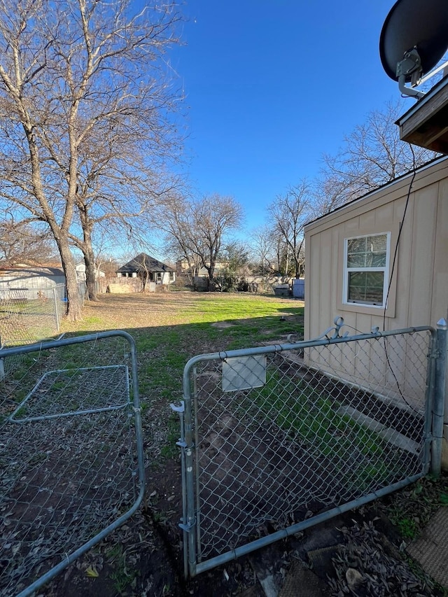 view of yard featuring fence and a gate