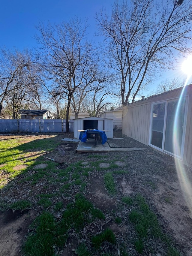 view of yard with fence and an outbuilding