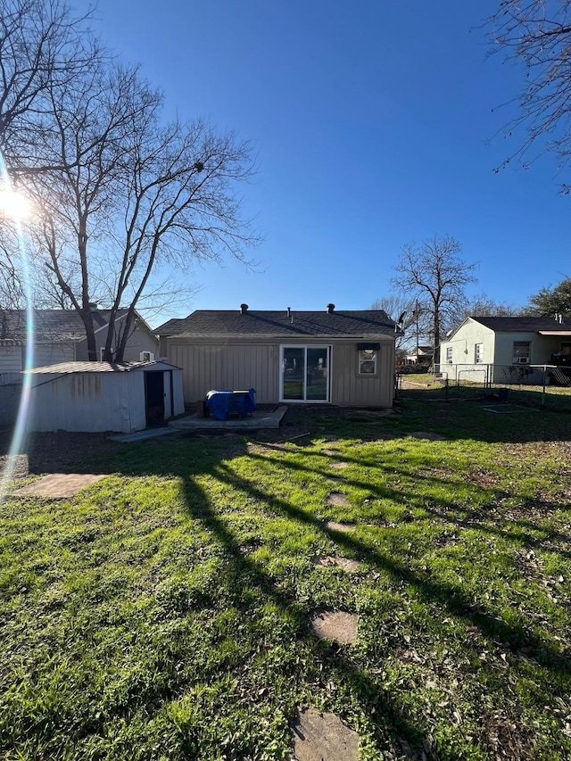 back of property with board and batten siding, a lawn, and fence