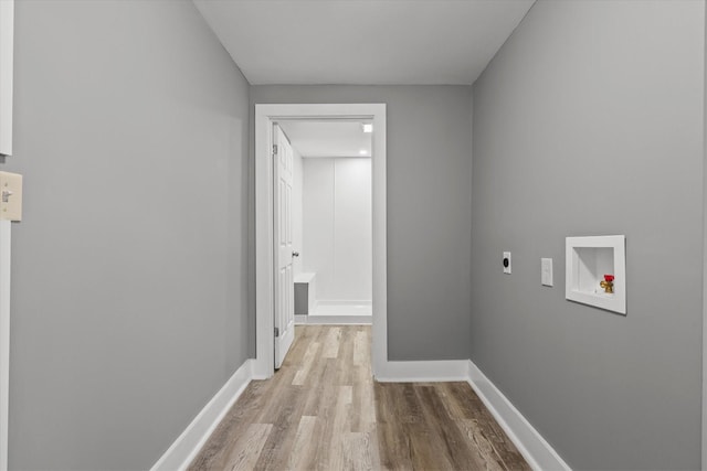laundry room with wood finished floors, hookup for a washing machine, baseboards, and electric dryer hookup
