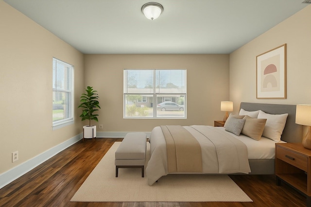 bedroom with baseboards and dark wood-type flooring