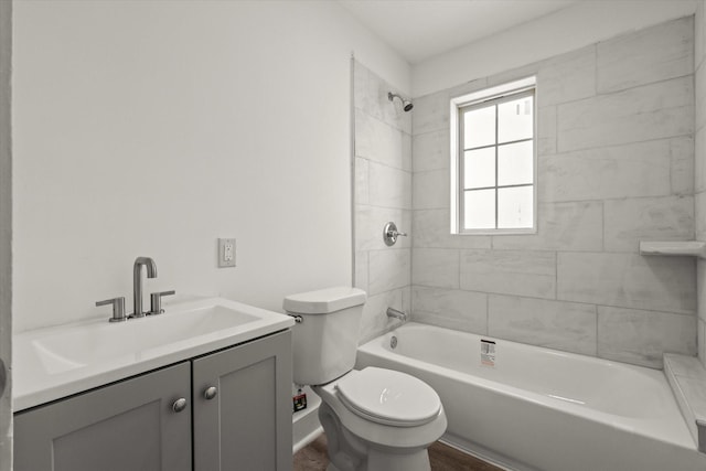 bathroom featuring toilet, vanity, wood finished floors, and shower / bathing tub combination