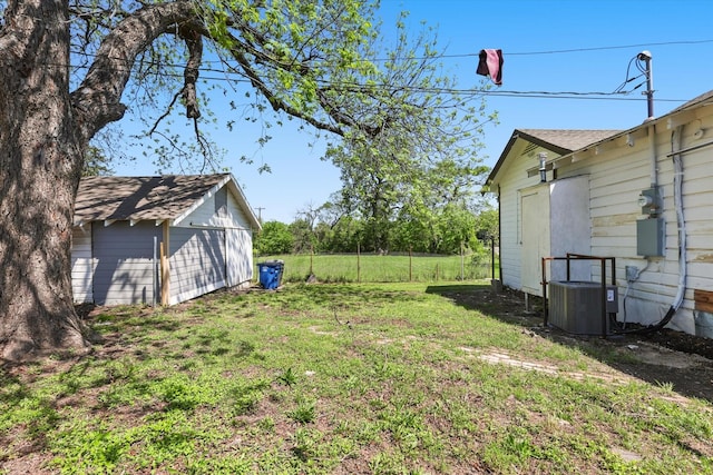 view of yard with an outbuilding and central AC unit