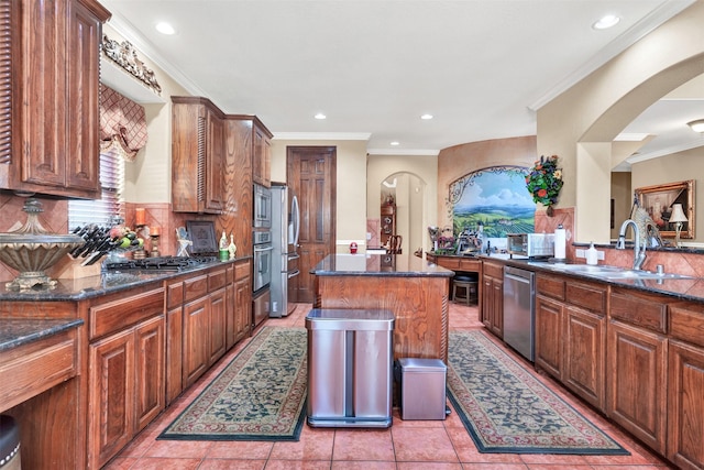 1547 Sandstone Dr, Frisco, TX 75034 - kitchen featuring dark stone countertops, tasteful backsplash, appliances with stainless steel finishes, light tile patterned flooring, and ornamental molding