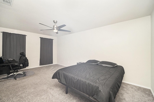 carpeted bedroom with visible vents, baseboards, and ceiling fan