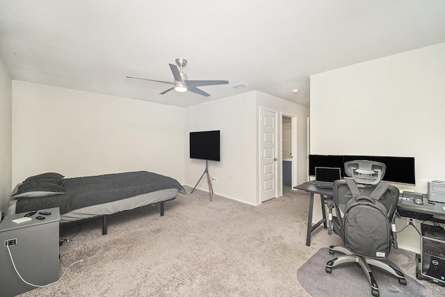 home office featuring light carpet, baseboards, ceiling fan, and visible vents