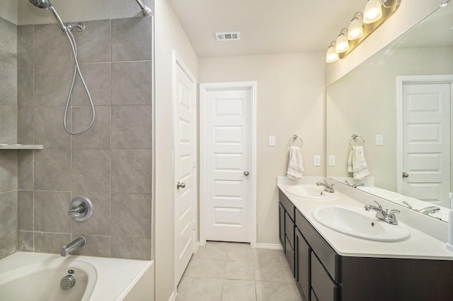full bathroom with tile patterned floors, a sink, visible vents, and bathing tub / shower combination