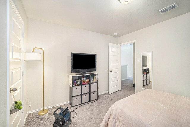 carpeted bedroom featuring visible vents and baseboards