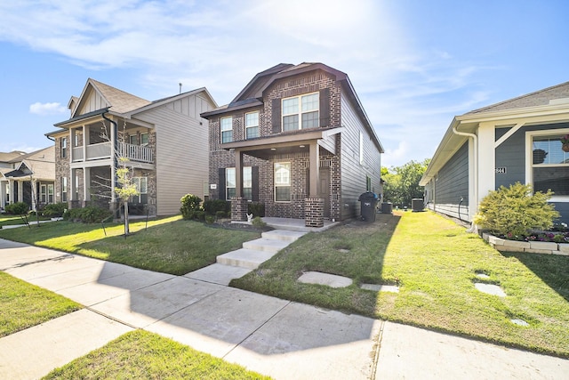 view of front of home with a front lawn and brick siding