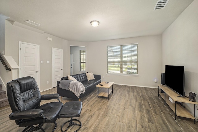 living room with wood finished floors and visible vents