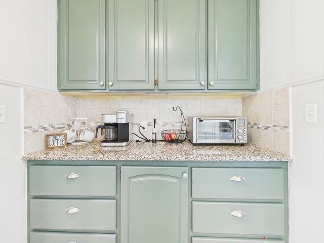 bar with decorative backsplash and a toaster