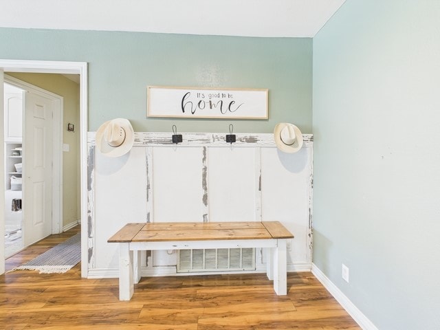mudroom featuring light wood-type flooring and baseboards