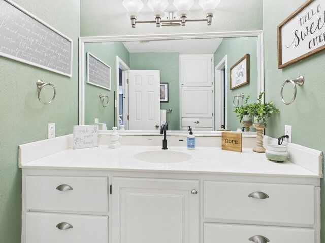 bathroom featuring vanity and a notable chandelier