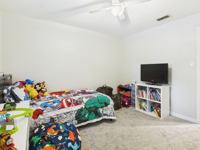 bedroom with a ceiling fan, carpet flooring, and visible vents