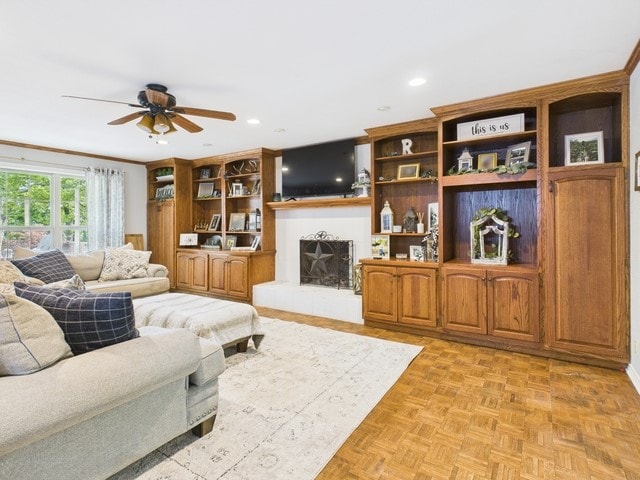 living area featuring recessed lighting, a fireplace with raised hearth, and ceiling fan