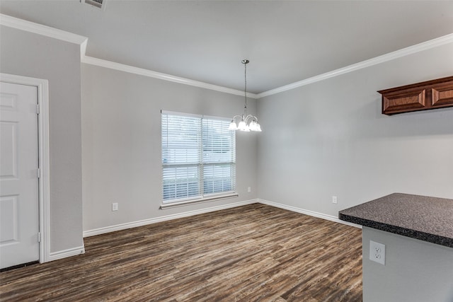 unfurnished dining area with baseboards, an inviting chandelier, ornamental molding, and dark wood finished floors