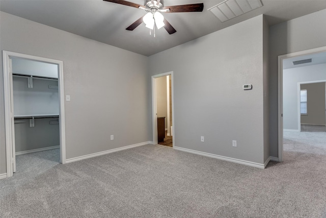 unfurnished bedroom featuring a spacious closet, visible vents, and carpet
