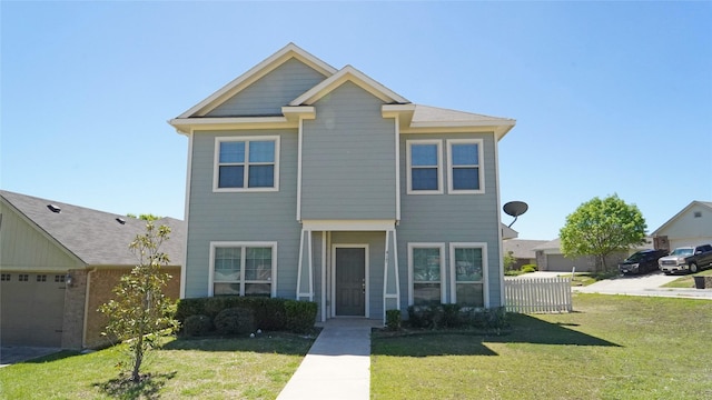 view of front of home featuring a front lawn and a garage