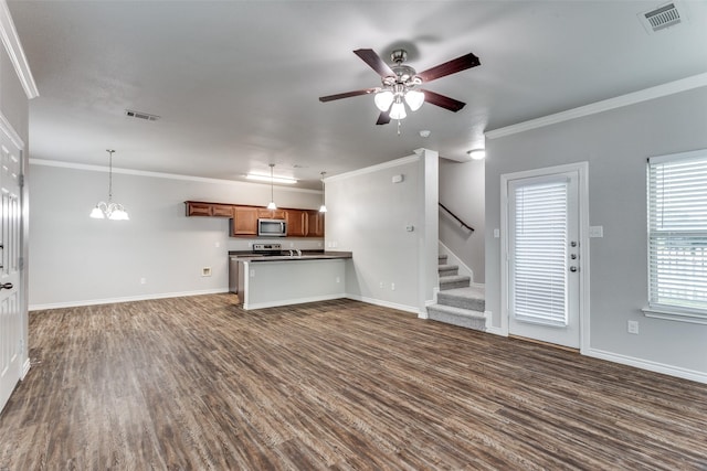 unfurnished living room featuring ceiling fan with notable chandelier, visible vents, dark wood-style floors, and ornamental molding