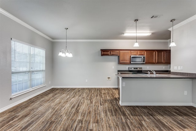 kitchen featuring dark wood finished floors, dark countertops, stainless steel appliances, and visible vents