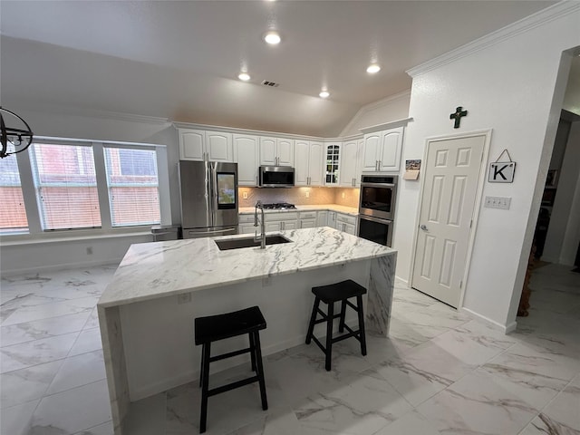 kitchen with marble finish floor, stainless steel appliances, a sink, crown molding, and baseboards