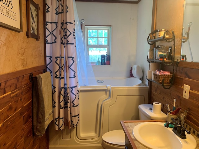bathroom featuring curtained shower, toilet, vanity, and a bathing tub
