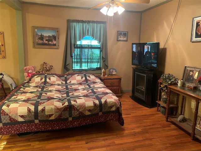 bedroom with hardwood / wood-style flooring and ceiling fan