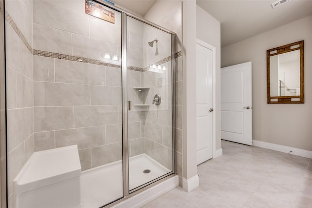 bathroom featuring baseboards, visible vents, and a stall shower